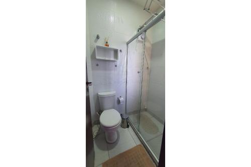 a bathroom with a toilet and a glass shower at Gravatá sonho de estadia - 928 in Gravatá