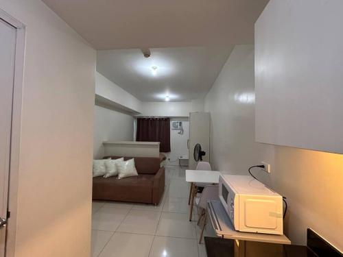 a small living room with a couch and a bedroom at Sweden's Tiny Home, Studio Unit Condo in Manila