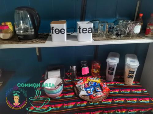 a shelf with coffee cups and other items on it at Posada Vs4 Aeropuerto in Mexico City
