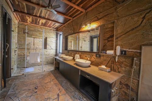 a large bathroom with a sink and a shower at AamaGhati Wildlife Resort, Ranthambore in Sawāi Mādhopur