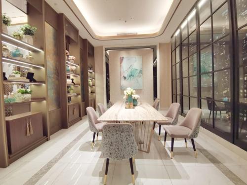 a dining room with a table and chairs at Benson Tower Surabaya Apartment 2BR by Le Ciel Hospitality in Lontar