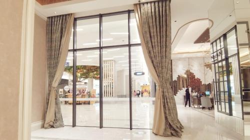 a large glass door in a shopping mall at Benson Tower Surabaya Apartment 2BR by Le Ciel Hospitality in Lontar