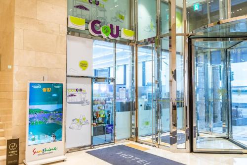 an entrance to a store with revolving glass doors at Gwangyang Lacky Hotel in Gwangyang