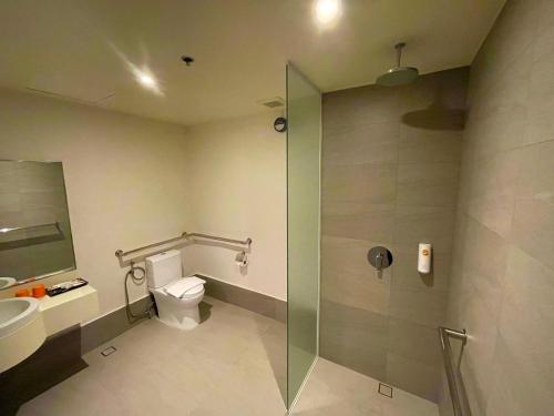 a bathroom with a toilet and a glass shower at Go Hotels Plus Mandaluyong in Manila