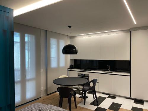 a kitchen with a table and chairs in a room at A10 Palazzo Marconi Apartment in San Giovanni Valdarno