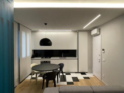 a kitchen with a table and chairs in a room at A10 Palazzo Marconi Apartment in San Giovanni Valdarno