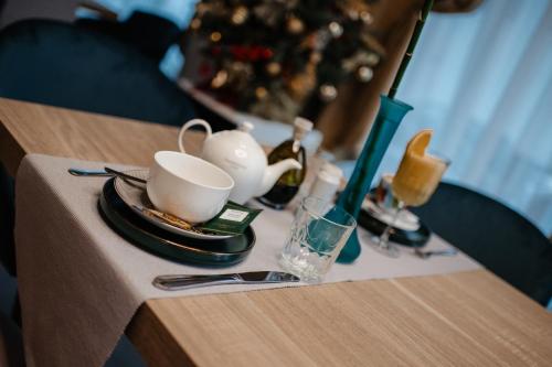 a table with a cup and a vase on it at Hotel Clipa in Drobeta-Turnu Severin