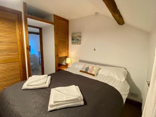 a bedroom with a bed with two towels on it at Seven Stars Inn in Builth Wells