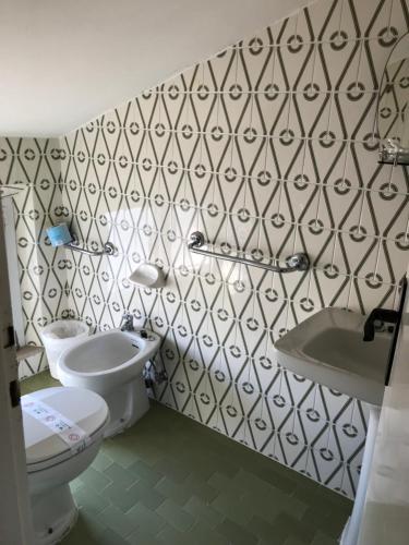 a bathroom with a toilet and a sink at Hotel Perla Verde in Rimini