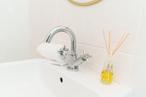 a kitchen sink with a roll of paper towels next to a faucet at St Johns House in Leeds