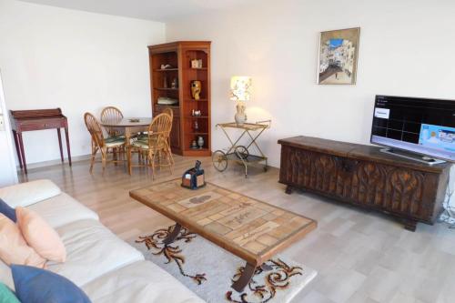 a living room with a couch and a coffee table at Spacious T2 "Jardin du Pont du Lys" with pool and parking in Antibes