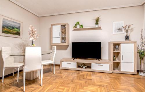 A television and/or entertainment centre at Stunning Apartment In Gijón With Wifi