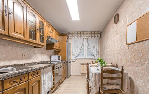 A kitchen or kitchenette at Stunning Apartment In Gijón With Wifi