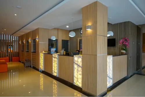 a lobby with a reception desk in a building at TwoSpaces Living at KR Hotel in Palembang