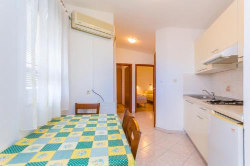 a kitchen with a table with a checkered floor at Barbic in Medulin