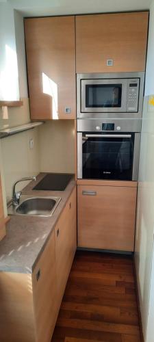 a small kitchen with a microwave and a sink at CityCenter in Belgrade