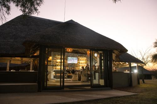 a store front with a large black umbrella at Mongena Private Game Lodge in Rust de Winter