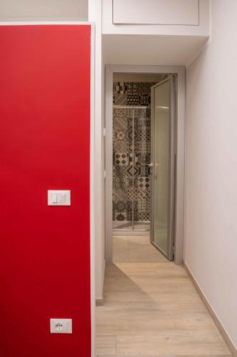 a red door in a room with a red wall at Terranova49 in Novara