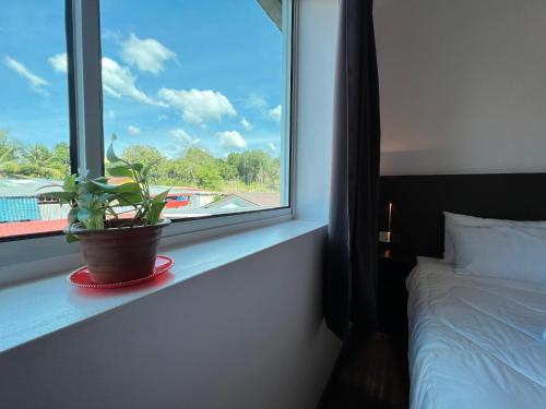 Postel nebo postele na pokoji v ubytování MG Kuah Langkawi