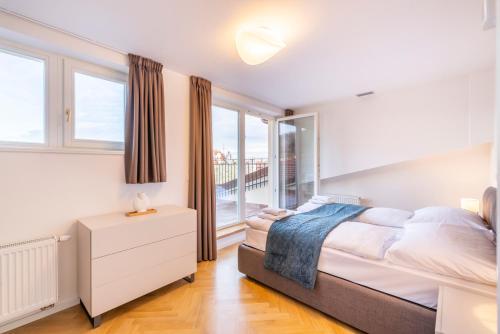 a bedroom with a bed and a window at Petrin Tower Residence in Prague