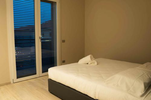 a bedroom with a bed and a large window at Terranova49 in Novara