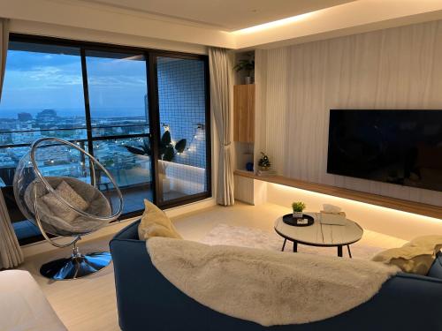 a living room with a couch and a large window at 暮嶼 twilight island in Toucheng