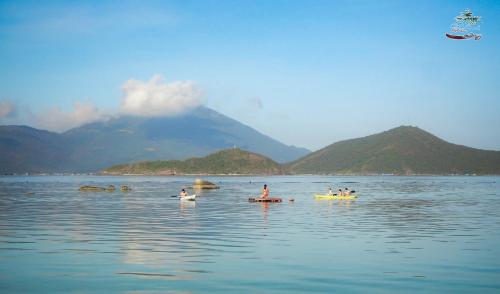 a group of people on kayaks in a body of water at Whale Island Resort in Dam Mon