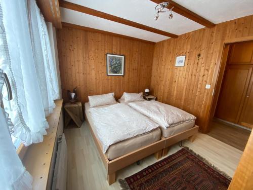 a bedroom with a bed in a wooden wall at Jack in Schwarzsee