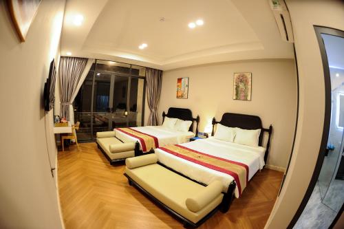 ein Hotelzimmer mit 2 Betten und 2 Stühlen in der Unterkunft LAHONA HOTEL in La Gi