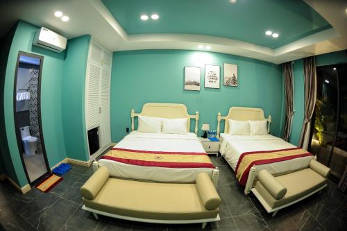 a hospital room with two beds and a chair at LAHONA HOTEL in La Gi