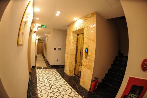 a hallway of a building with stairs and a door at LAHONA HOTEL in La Gi