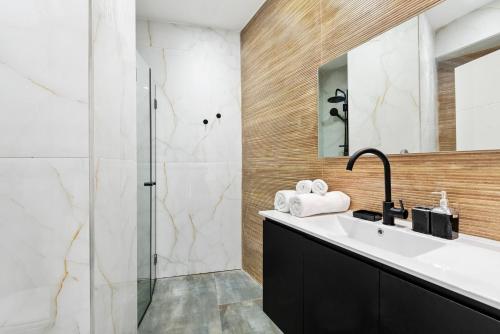 a bathroom with a sink and a shower at Lively new apt with Bomb Shelter beside the beach M5 in Tel Aviv