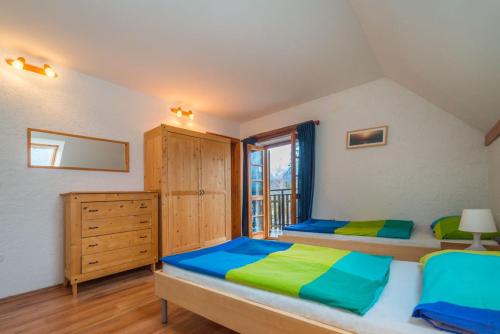 a bedroom with two beds and a window at Mala Vas Chalet in Bovec