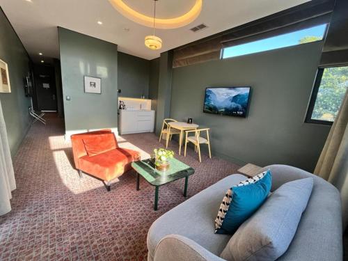 a living room with a couch and a table at Home Suite Hotels Rosebank in Johannesburg