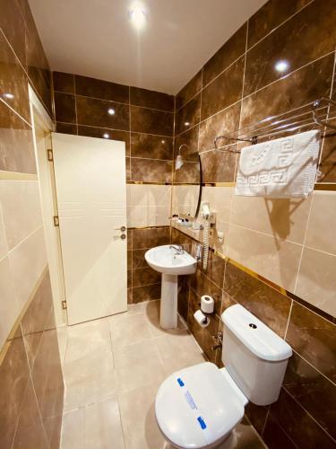 a bathroom with a toilet and a sink at Adora Hotel in Istanbul