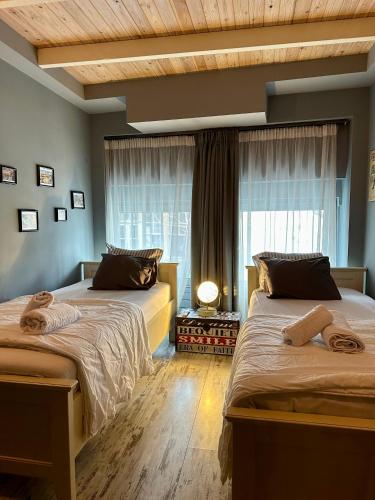 a bedroom with two beds and a window at Kamares View in Kavala
