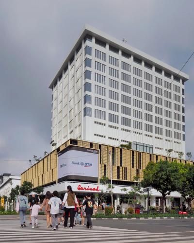 a group of people walking in front of a large building at Ashley Tanah Abang in Jakarta