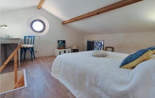 a bedroom with a large white bed and a window at Beautiful Apartment In La Gaude With Kitchenette in La Gaude