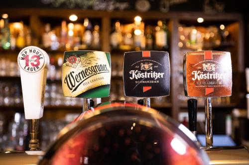 three different types of beer glasses on a bar at Pension Friedrichshof in Bad Klosterlausnitz