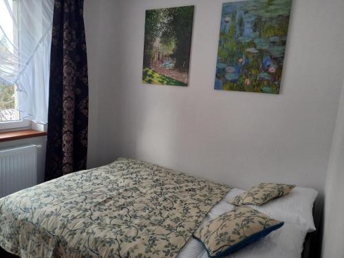 a bedroom with a bed and two paintings on the wall at APARTHOTEL Apartamenty KORONA noclegi przy Termach Cieplickich 10proc rabatu do TERM Jelenia Góra Cieplice SELF CHECK IN in Jelenia Góra