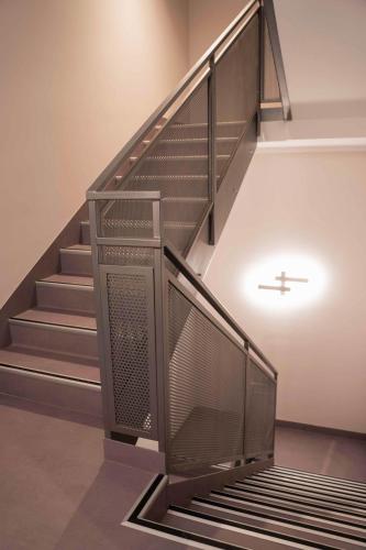 a staircase with a metal railing in a building at Terranova49 in Novara