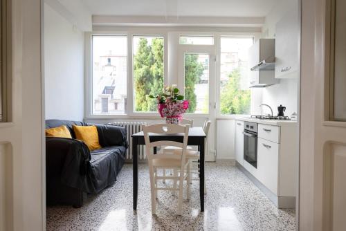 a kitchen and living room with a table and a couch at B & B L'ABBRACCIO in Agnone