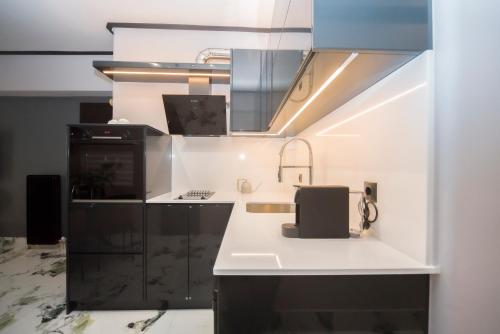 a kitchen with a sink and a counter top at Luxury Premium Suite #4 in Chalkida