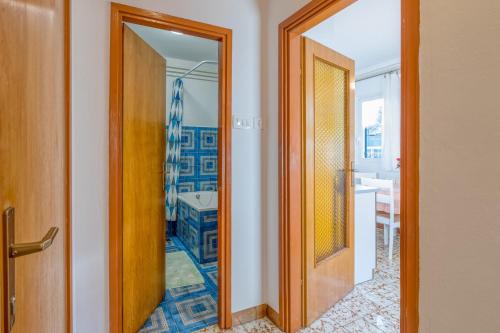 a hallway with a door leading to a bathroom at Apartment Complex Nevia in Poreč