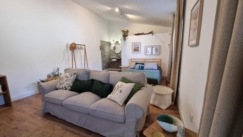 a living room with a couch and a bed at Quintinha do Sal - Casa das Flores in Alcácer do Sal