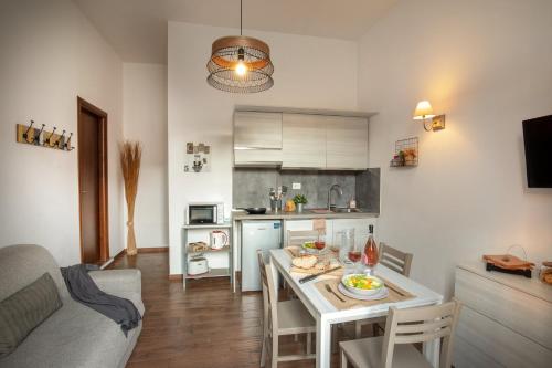 a kitchen and a living room with a table in a room at Fornaci Vatican Flat in Rome