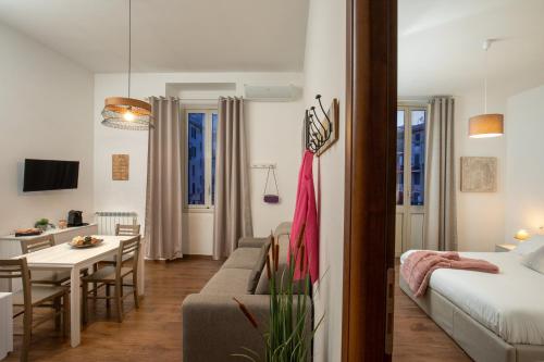 a living room with a bed and a dining room at Fornaci Vatican Flat in Rome