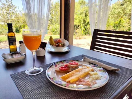 a table with a plate of food and a glass of orange juice at Agroturismo Can Marquet - Adults Only in Santa Gertrudis de Fruitera