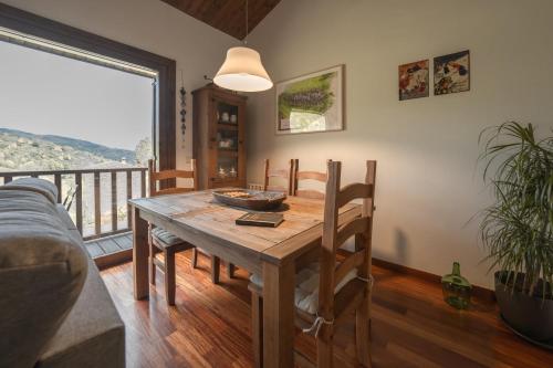 a dining room with a table and a balcony at CAN ROC in Camprodon