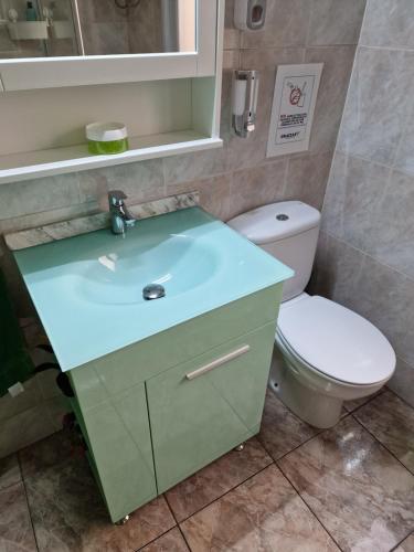 a bathroom with a sink and a toilet at Apartment & Beach - Airport in Playa del Burrero